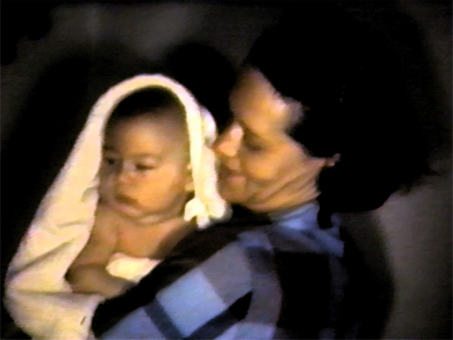 my mother holding her first healthy baby